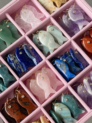 Colorful fish-shaped objects in a pink grid container